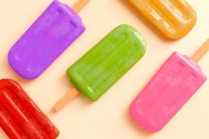 Colorful homemade popsicles made with fresh fruit and yogurt - perfect summer treat for kids and family